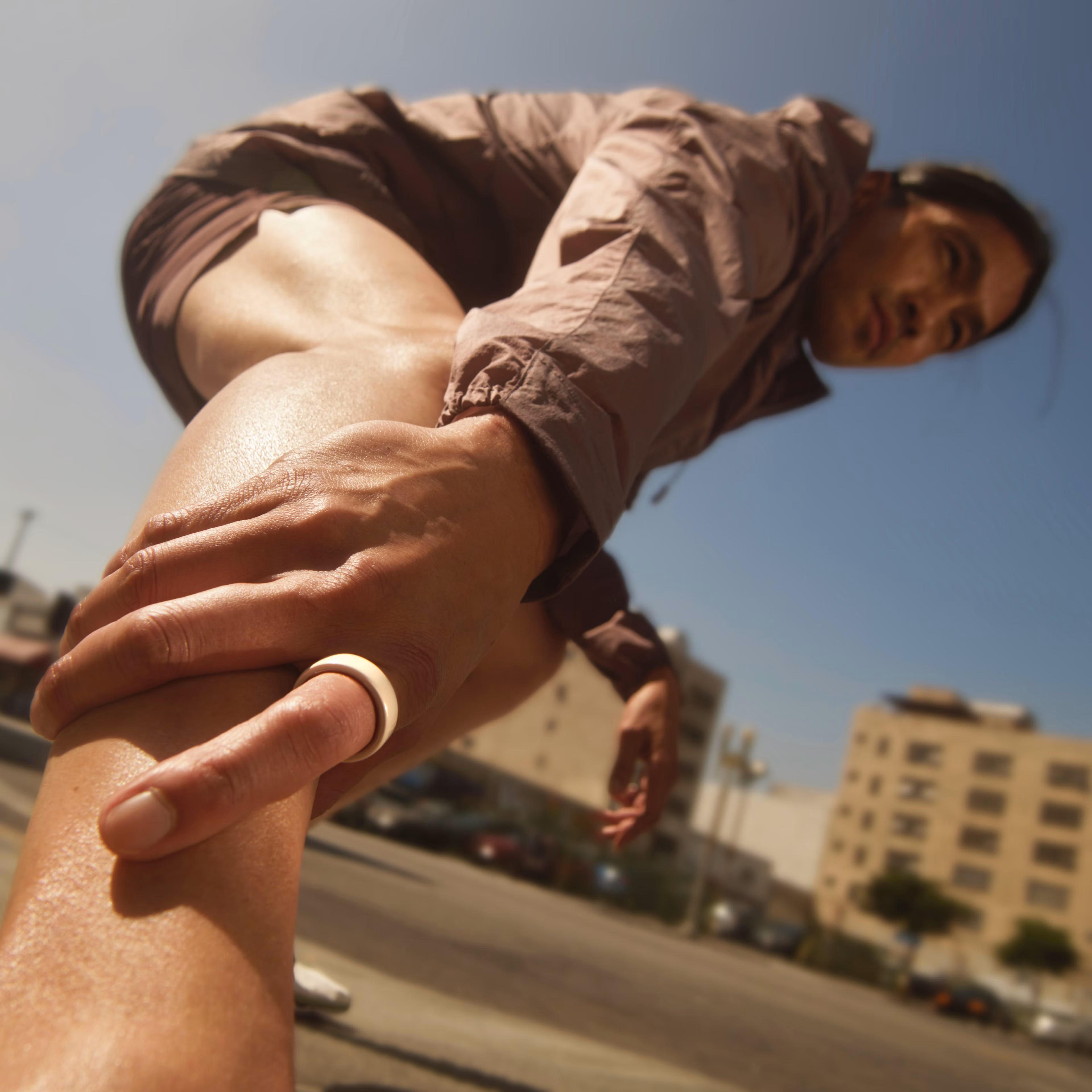 A person wearing a Cloud Oura Ring 4 Ceramic stretches their legs
